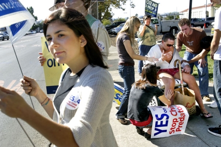 A youth missionary group from Hillside Christian Church form a prayer circle as Ally Rogers, 18, rallies on the corner of Jefferson and Lincoln streets for Proposition 8, a measure to ban gay marriage